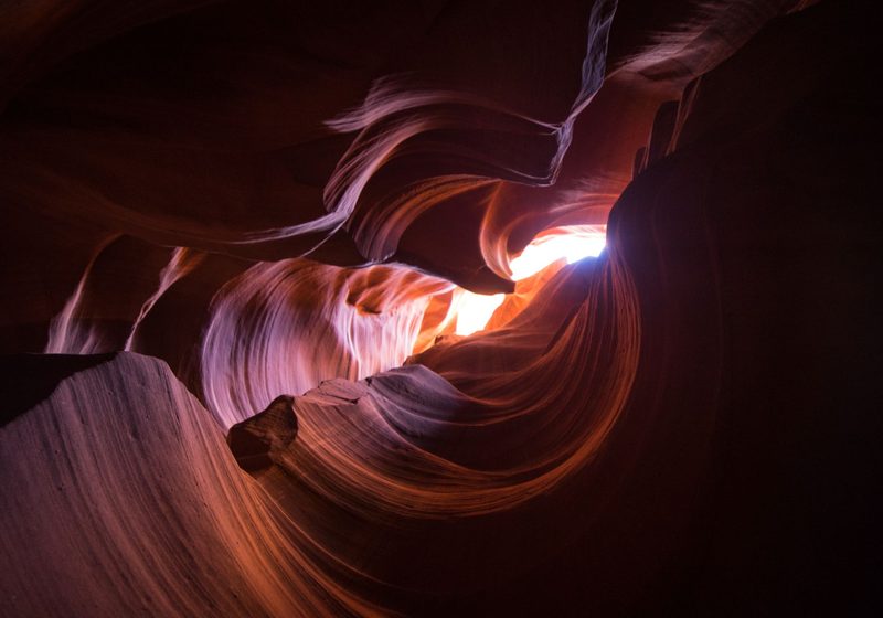 Swirling sandstone walls lit from above