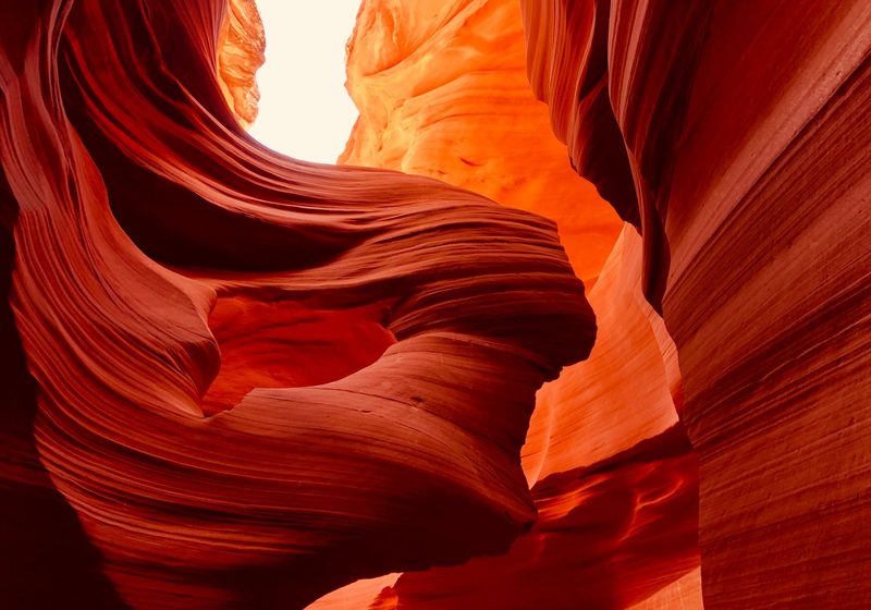 Curved orange sandstone shaped by water