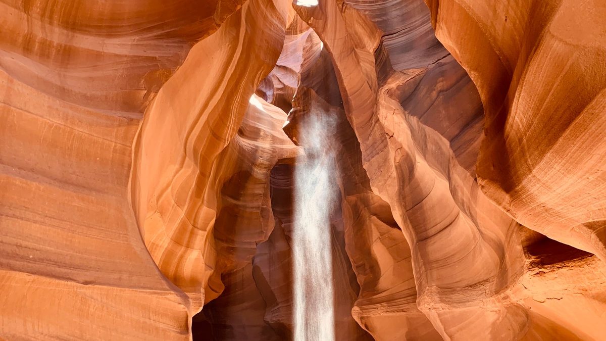 A thin beam of light in a sandstone canyon