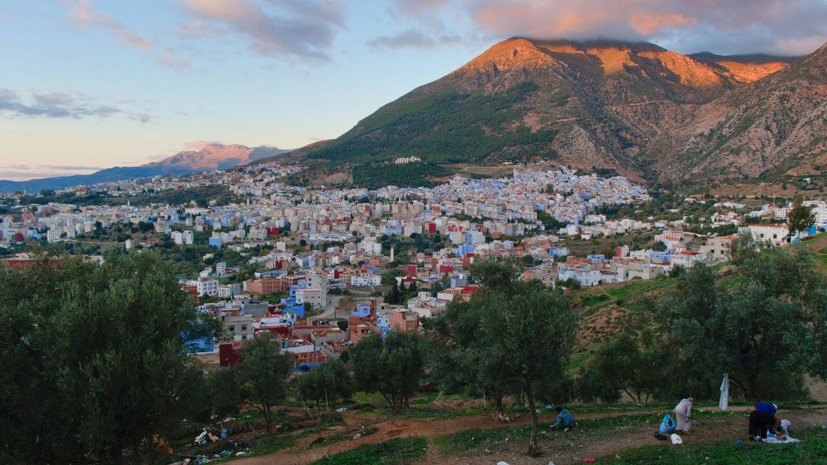 A town below the mountains at sunset
