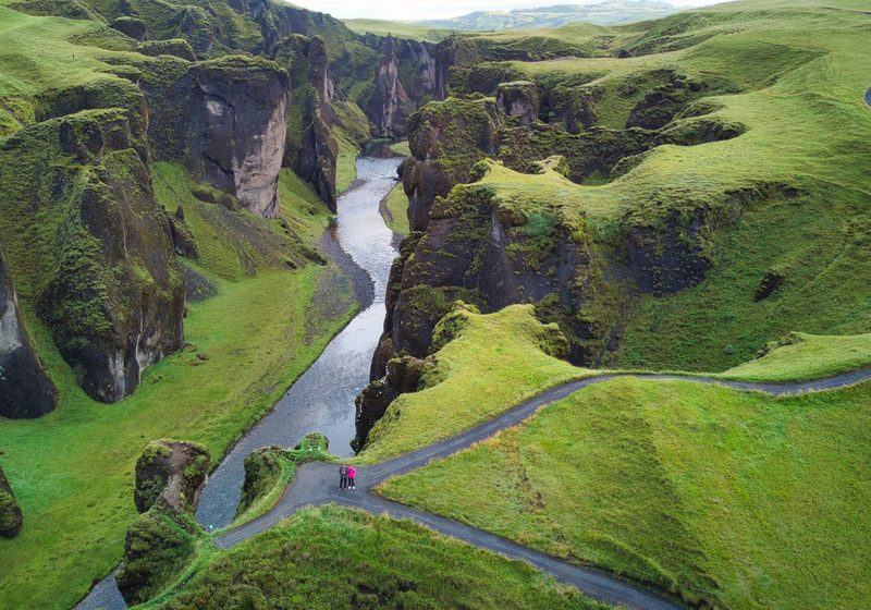 A road winding past the green canyon