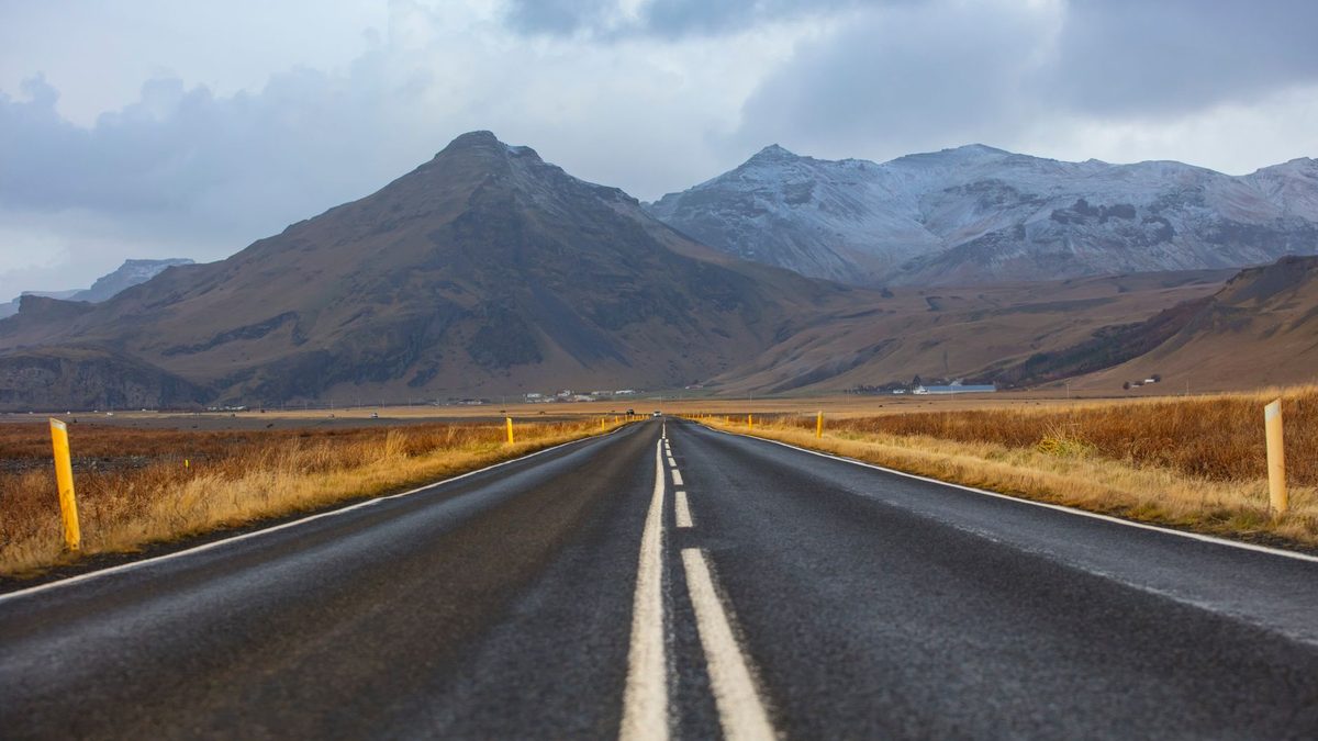 An empty road through a mountain landscape in Iceland