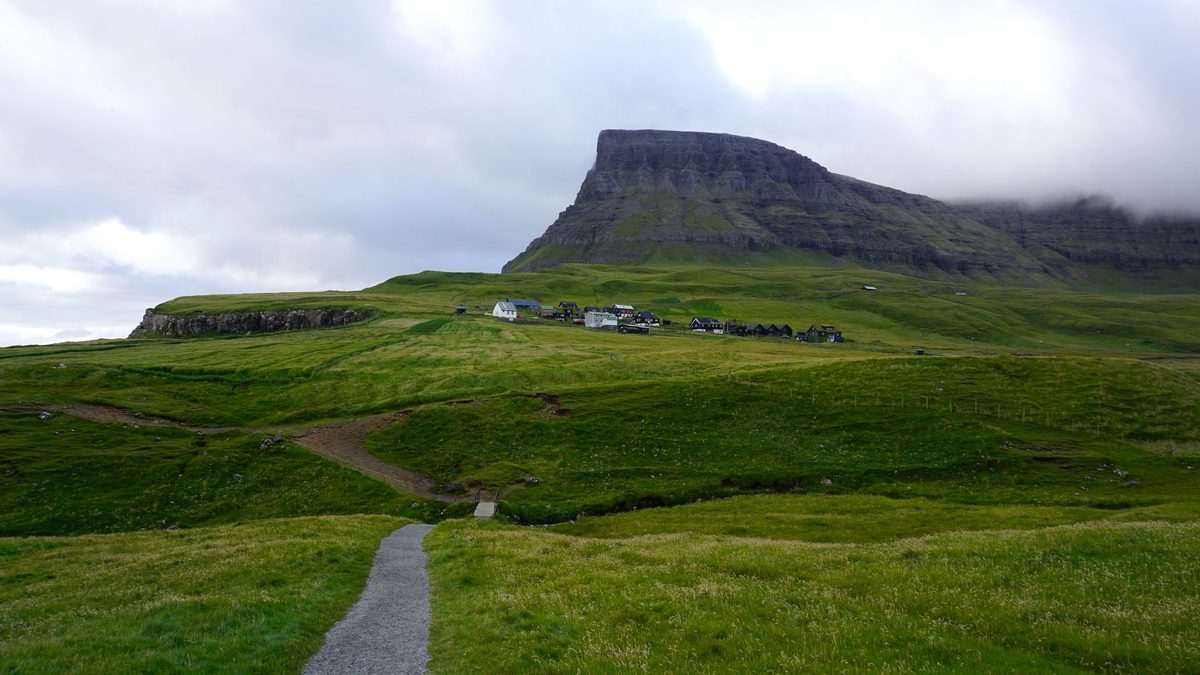 Green hills and a gravel path in the Faroe Islands