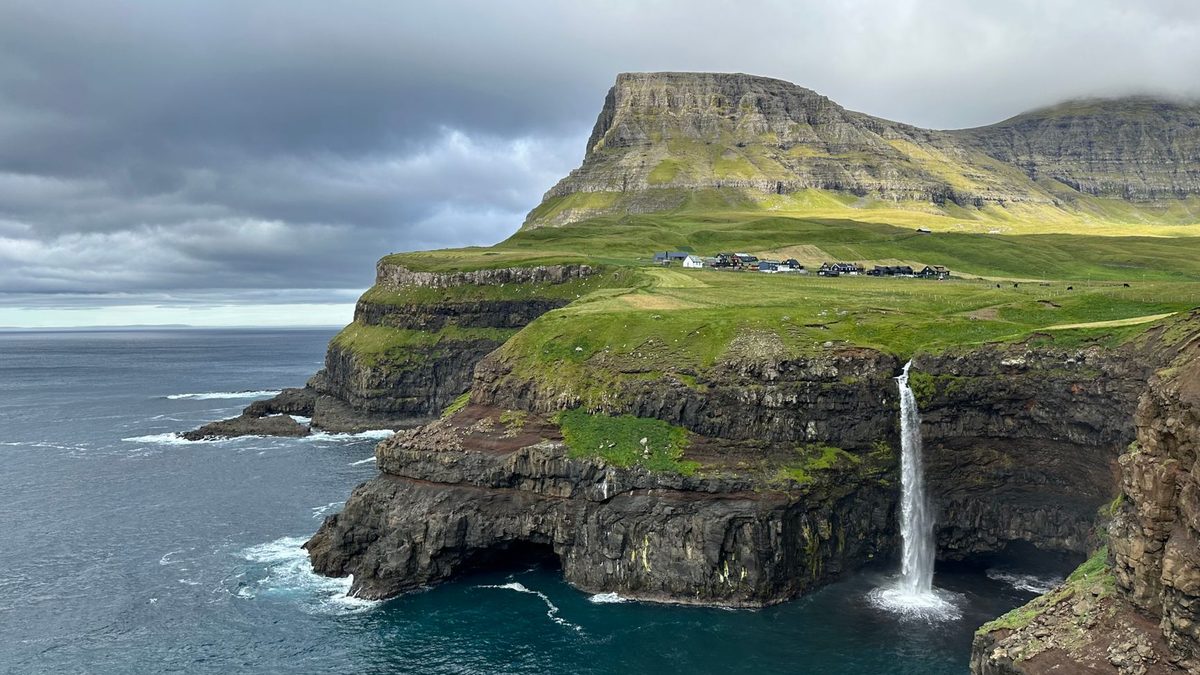 The Múlafossur waterfall and the cliffs of Gásadalur