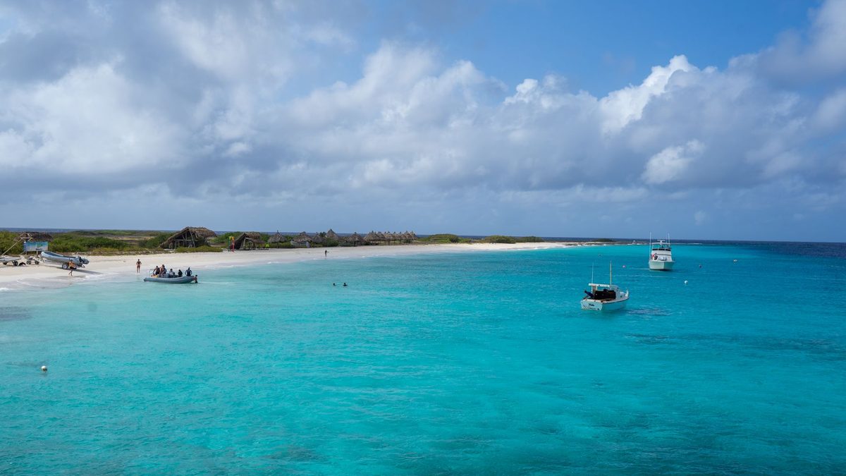 Clear turquoise water and a sandy beach on a sunny day