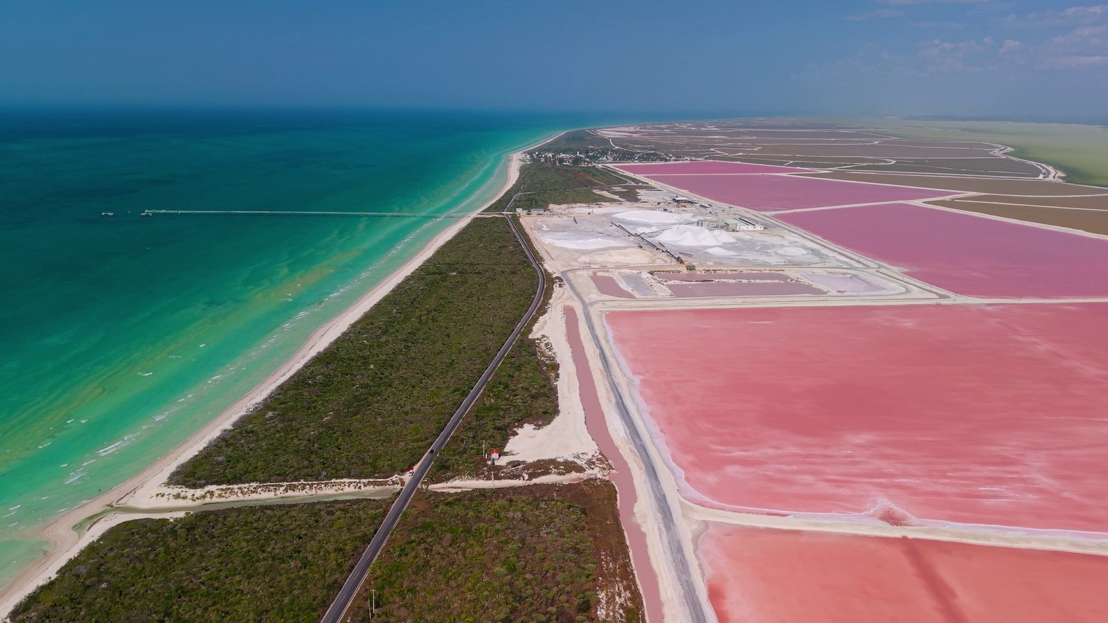 Pink salt ponds beside a turquoise sea at Las Coloradas