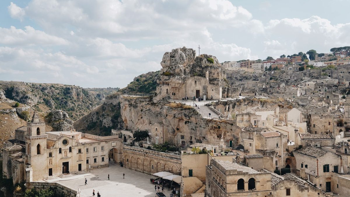 A piazza below a rock church in the Sassi