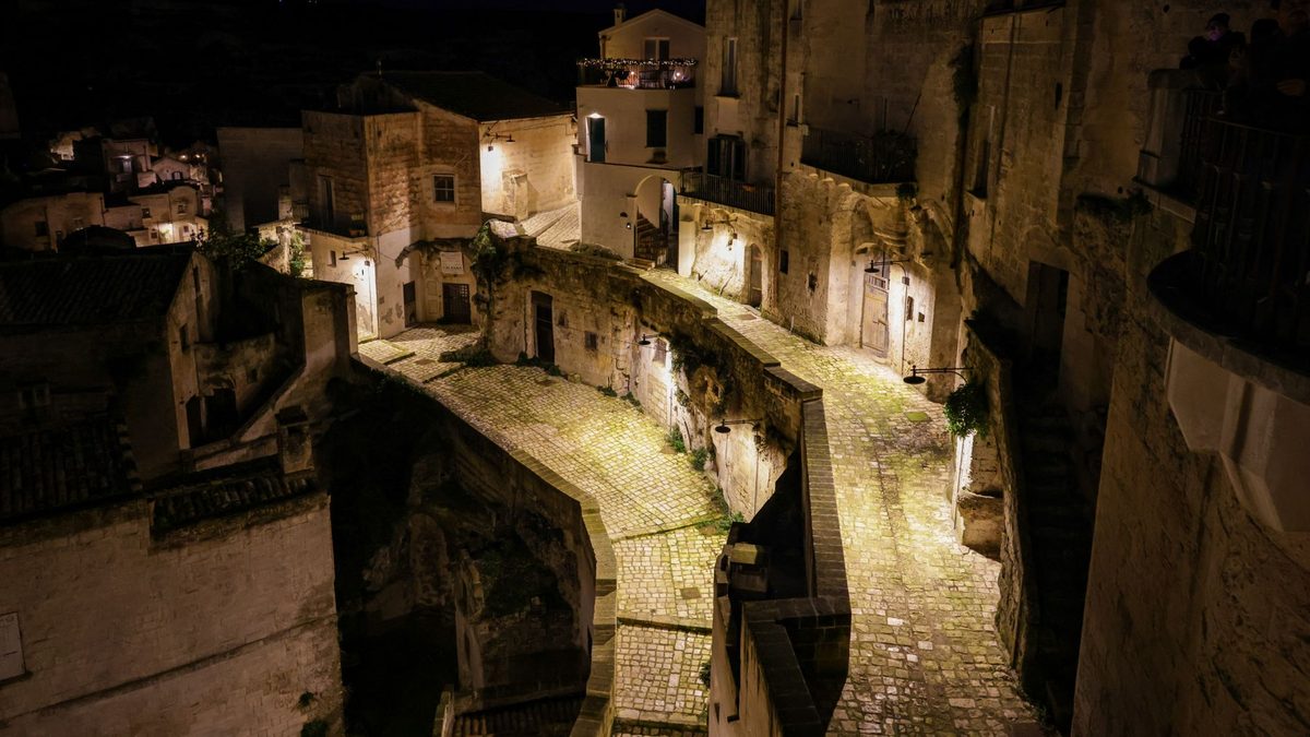 A stone street in the Sassi lit at night
