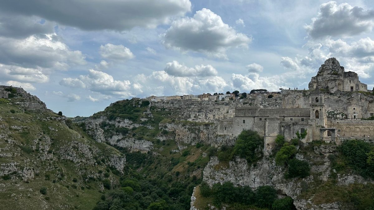 A rock church cut into the cliff above the ravine