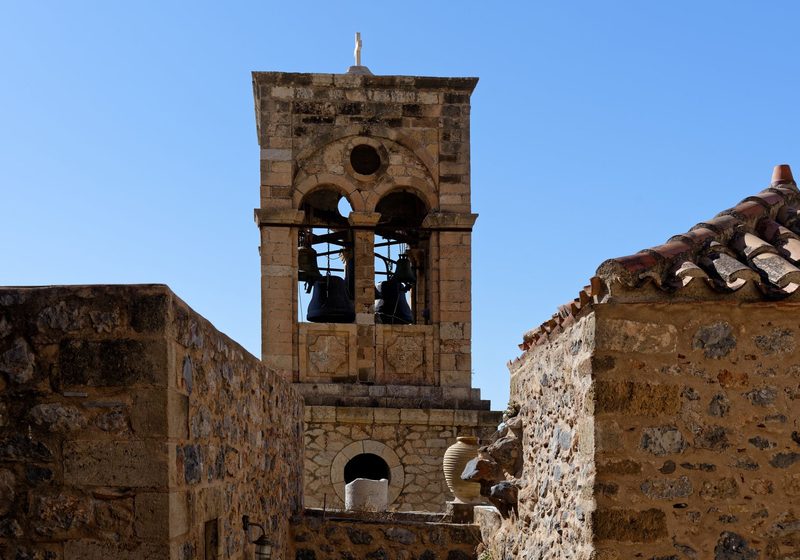 A stone bell tower against a blue sky