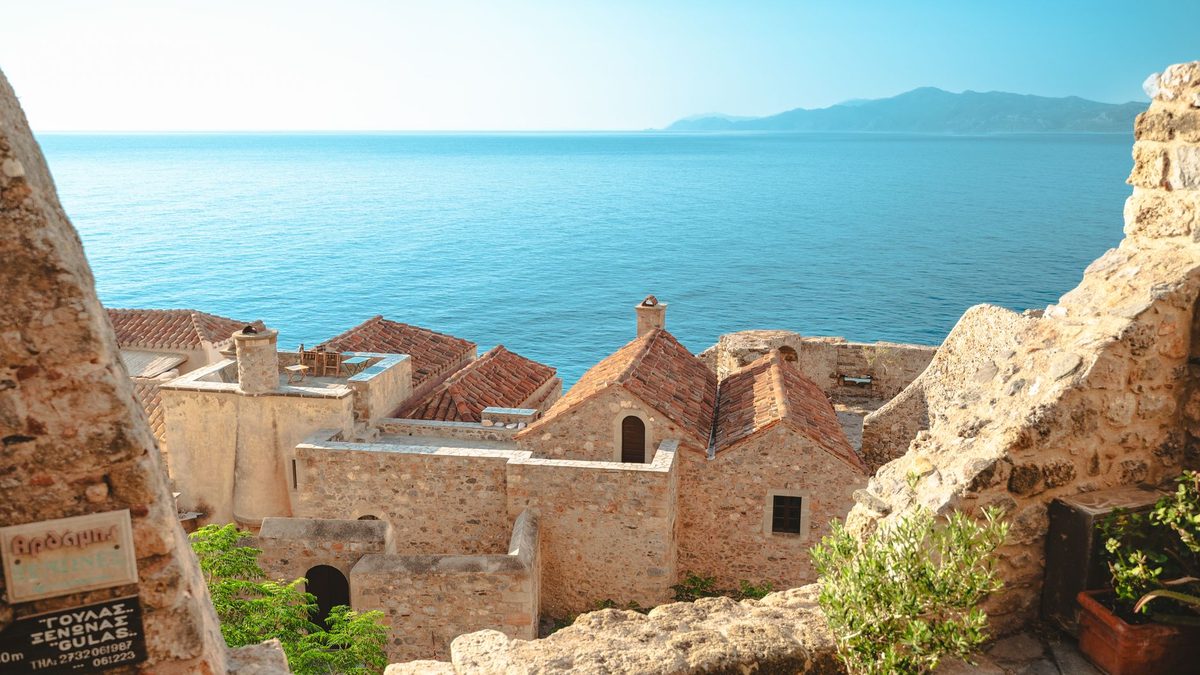 A sea view over tiled roofs on a clear day