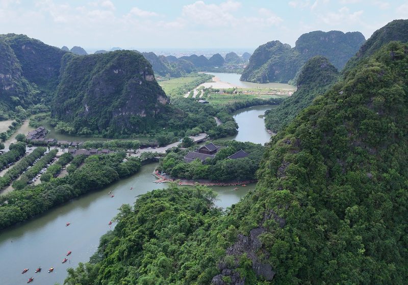 Limestone hills above a river and a temple