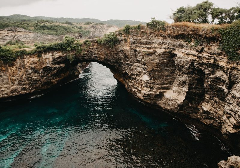 A natural rock arch over turquoise water