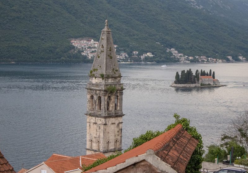 A bell tower in Perast with the island beyond