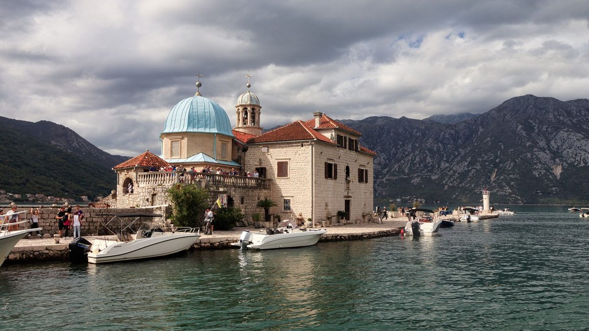 The church of Our Lady of the Rocks with boats at the landing