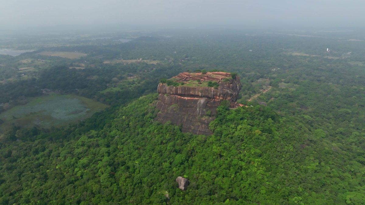 Sigiriya seen across a lake from the jungle