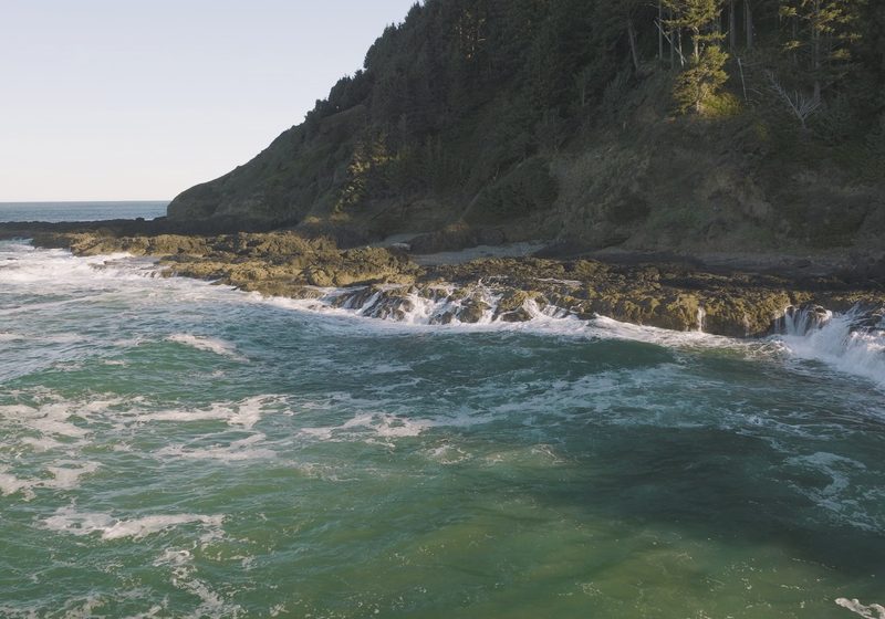 Green water surging over rock ledges