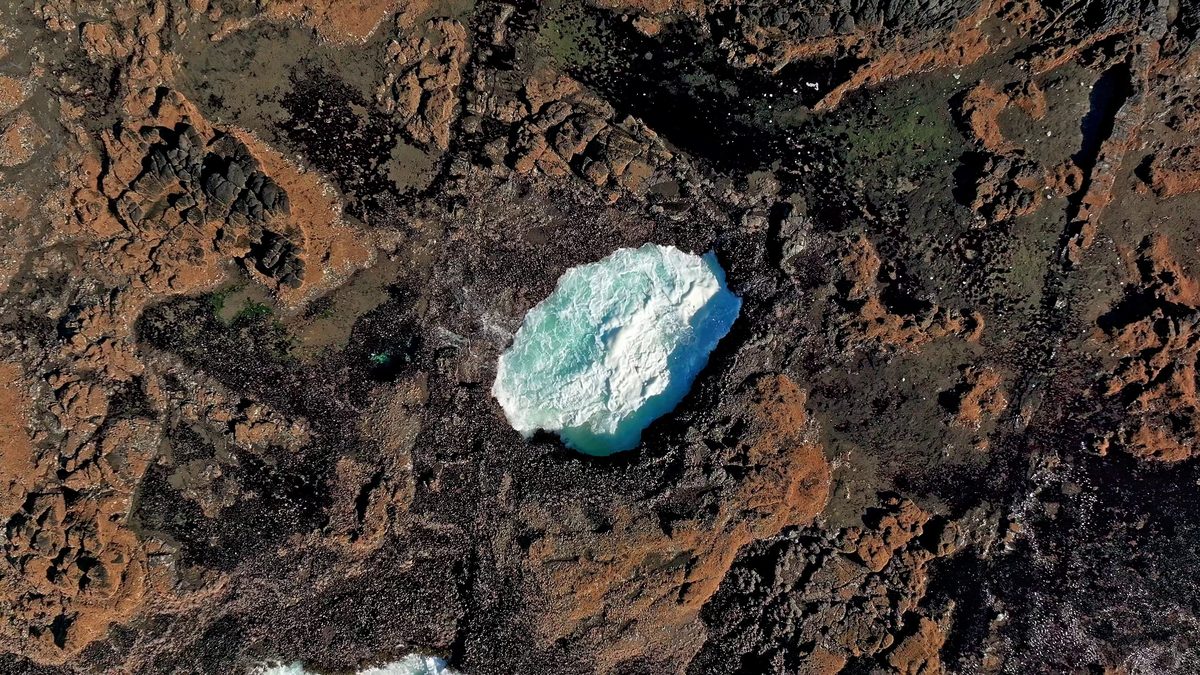 A foaming fountain in the rock seen from above